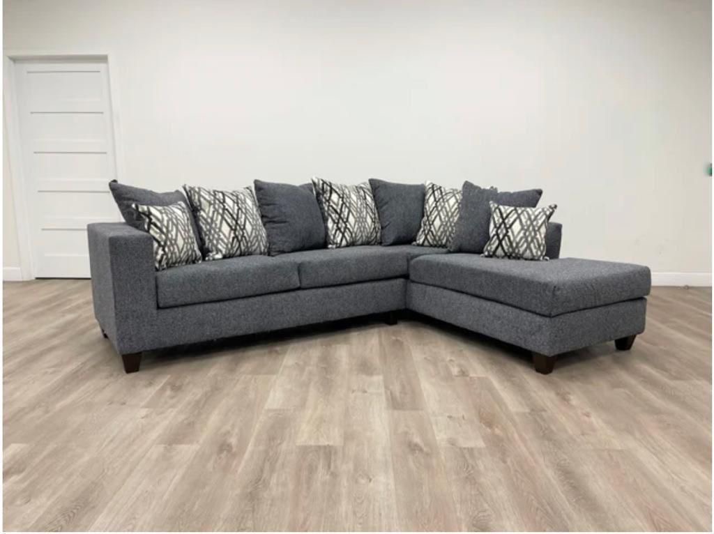 Charcoal grey sectional with diagonal pattern pillows