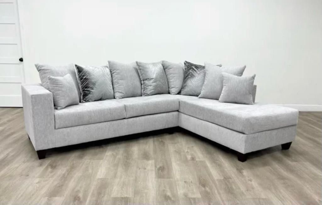 Light grey sectional with metallic chevron pillows