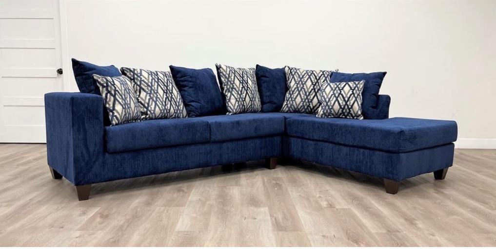 Navy velvet sectional with diamond pattern pillows