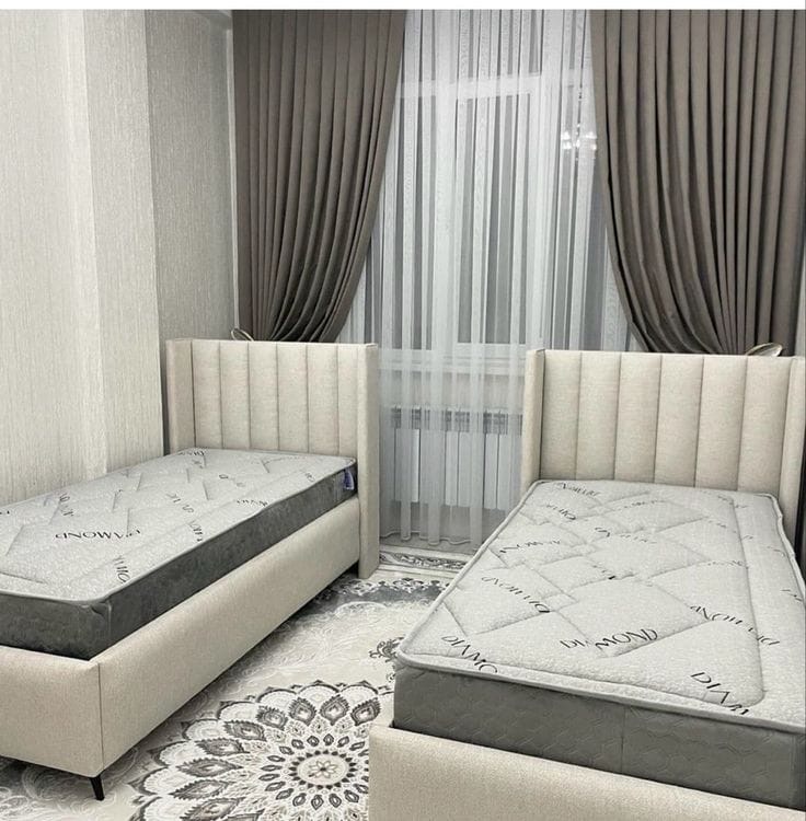 Twin bed set with cream upholstered headboards